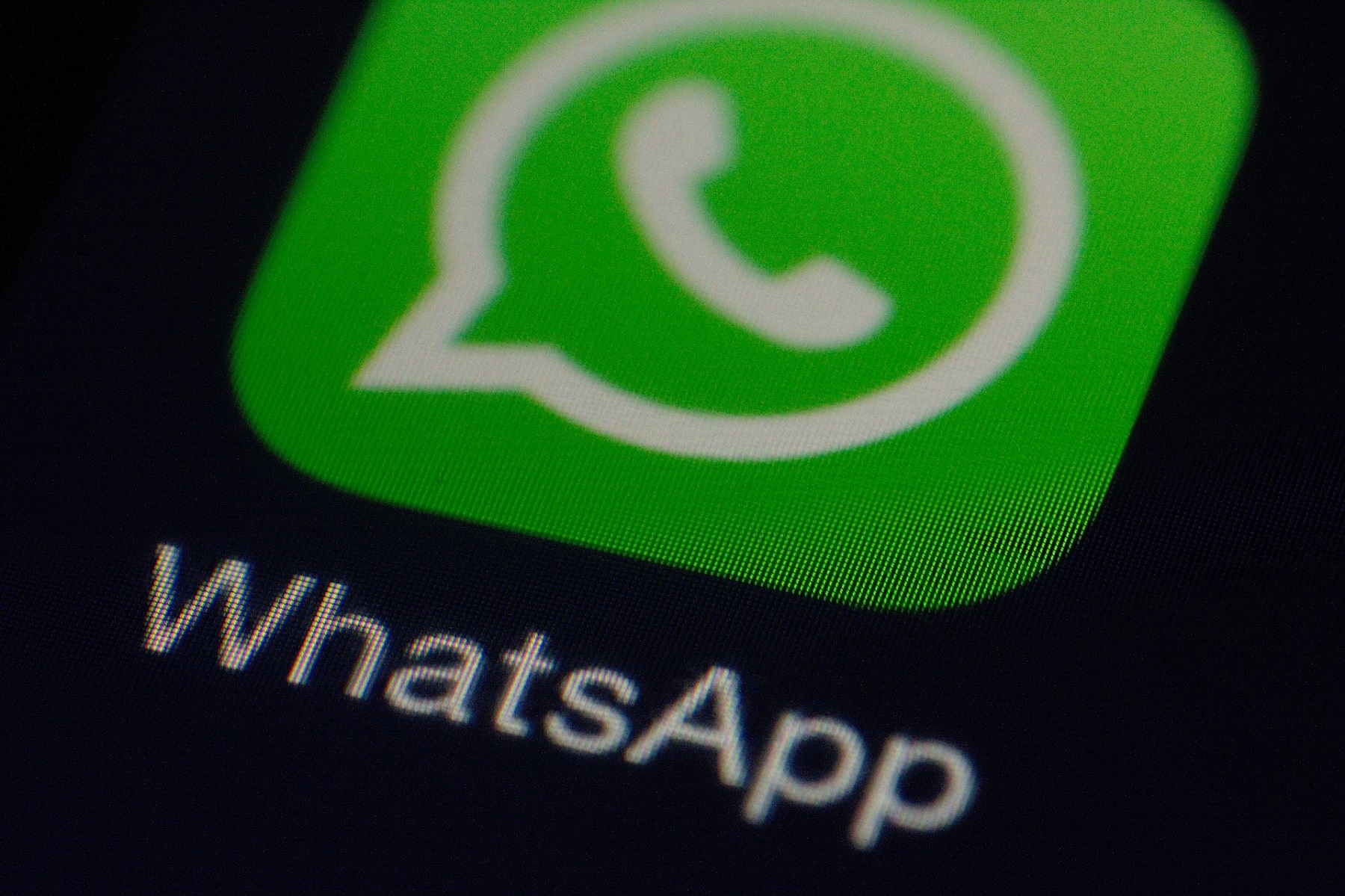 WhatsApp-Logo leicht angeschnitten auf schwarzem Hintergrund